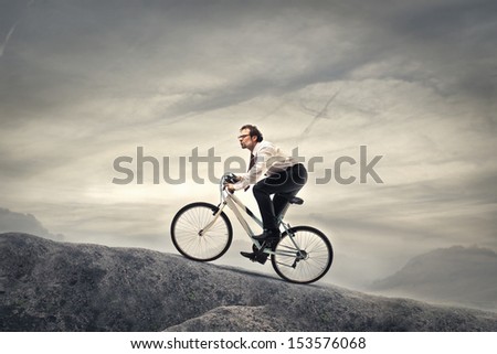 businessman cycling with fatigue in the high mountains