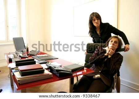 Two woman having an angry confrontation in a office