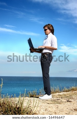 a man with a laptop at sea