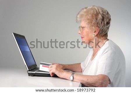 senior woman with laptop and credit card