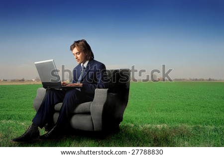 businessman using laptop in the country