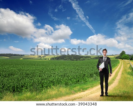 young businessman with laptop in the countryside