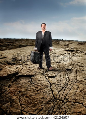 businessman with suitcase in the desert