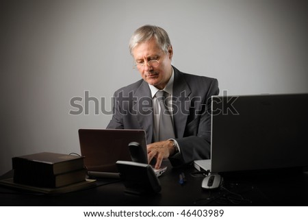 Portrait of a businessman using some IT devices