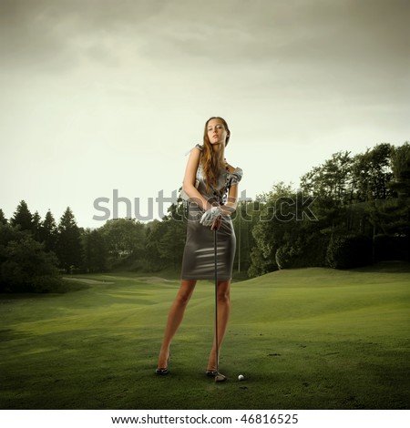 Portrait of a stylish beautiful woman holding a golf club on a green meadow