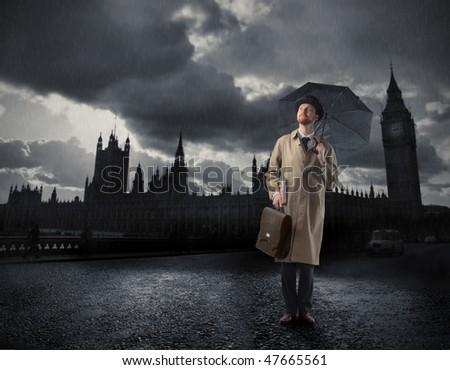 Portrait of a gentleman with an umbrella standing in front of the Big Ben