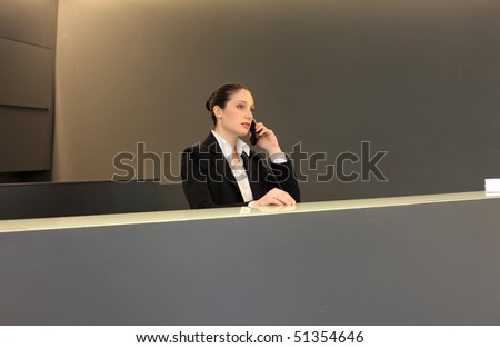Woman at the reception at the telephone