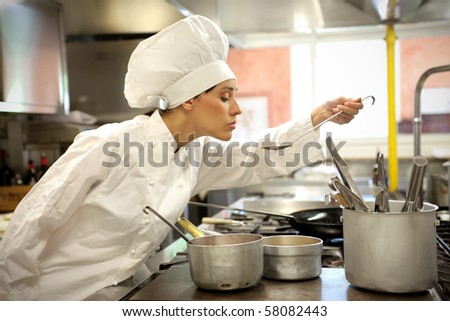 A chef is tasting her sauce