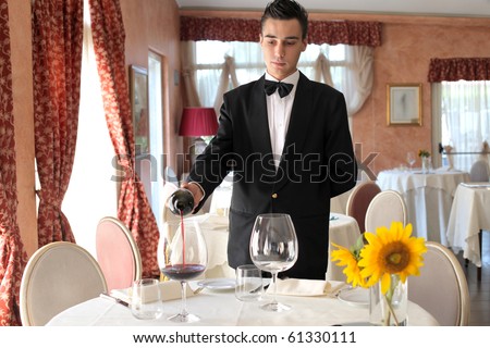 Waiter serving some wine in a luxury restaurant