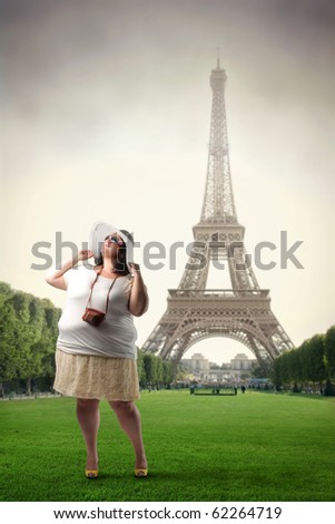 Fat woman standing in front of the Eiffel Tower
