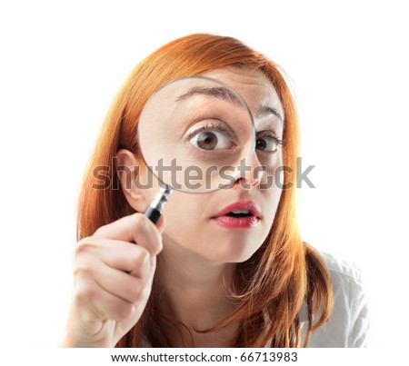 Woman looking through a magnifying glass