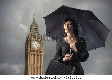 Elegant woman holding an umbrella with Big Ben on the background