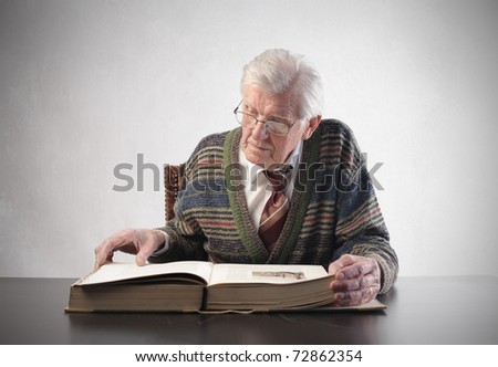 Senior man reading an old book