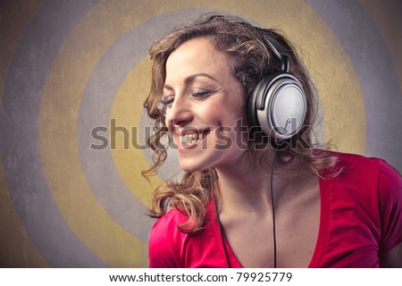 Smiling woman listening to music through headphones