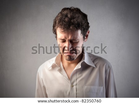 Sad young man crying