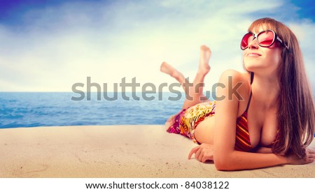 Beautiful woman in bikini sunbathing at the seaside