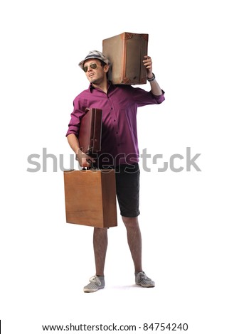 Young man carrying two big suitcases