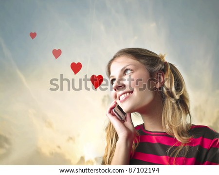 Smiling beautiful woman in love talking on the mobile phone