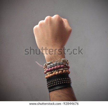 Closeup of a man\'s arm full of bracelets