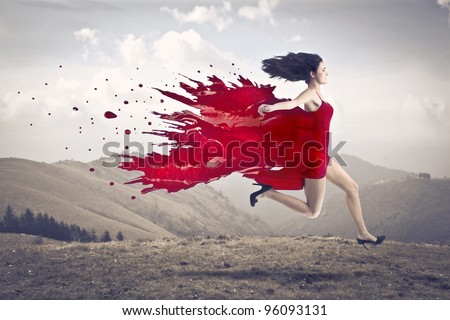 Beautiful woman running with her dress melting in red paint