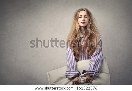 beautiful young woman just got up with pillow in hand