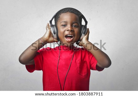 Similar – Image, Stock Photo Black child listening to music