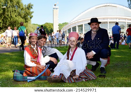 Tallinn, Estonia - July 07, 2014:Estonian XXVI National song and dance festival called Touched by time, Time to touch.Family in traditional clothes in Song Festival Grounds in Estonia on July 07, 2014