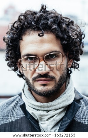 London in winter portrait of a serious young man of 33 years old with glasses