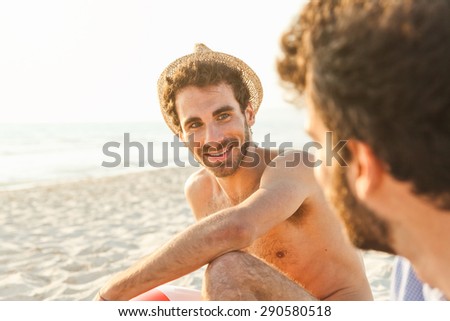 Portrait. Couple of male friends at sunset on the beach on a day of rest summer vacation together, after spending a day of relaxation and fun
