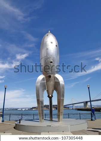 SAN FRANCISCO - OCT 2: A temporary art installation, the Raygun Gothic Rocketship, created by a team of Bay Area artists lead by Sean Orlando, Nathaniel Taylor, and David Shulman stands on a busy tourist promenade along the San Francisco Bay October 2, 20