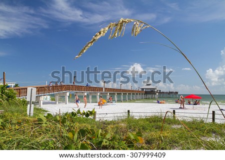 FORT MYERS BEACH PIER, TIMES SQUARE, FORT MYERS BEACH, FL, USA - July 21, 2015: A great destination to people watch, look for shells, watch amazing sunsets or fish from the pier.