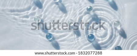 Abstract cosmetic water background for spa and moisturizing medical cosmetics Transparent granules on water background with splashes. Banner
