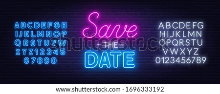 Save the date neon sign on brick wall background.