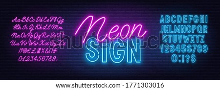 Neon duo pink and blue font. Bold and script alphabet on a brick wall background.