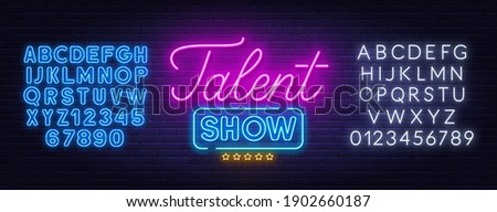 Talent show neon sign on brick wall background.