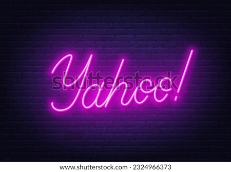 Yahoo neon sign on brick wall background.