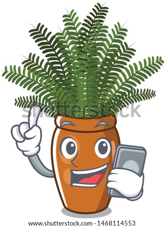 With phone boston fern grows in mascot pot