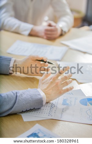 closeup of hands with financial charts at business meeting in the office