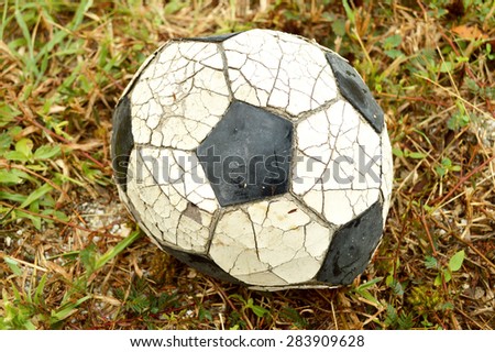 Very old soccer ball on the ground, vintage tone