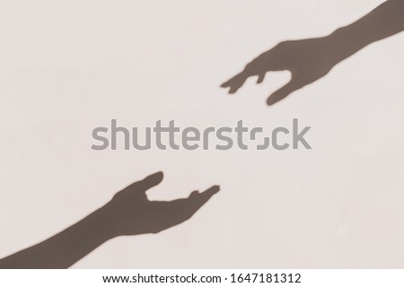 Similar – Image, Stock Photo Two shadows hands in red and green light circle.