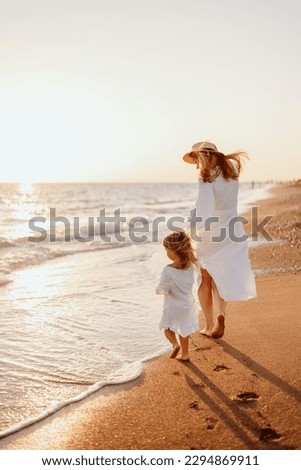 Image, Stock Photo Little girls walking barefoot on the sand and caring a picnic basket together. Summer leisure, love and friendship.