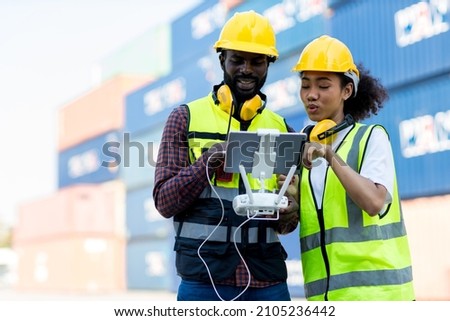 Foreman or worker use remote controller piloting drone at containers port for checking container. Foreman use remote control Drone with camera flying on container cargo ship at shipping port. Photo stock © 