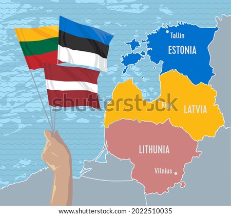 Hand holds the flags of Latvia, Lithuania and Estonia, which symbolizes unity for independence against the background of the map of the Baltic States.