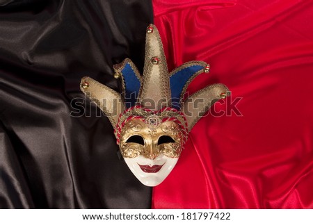 Carnival mask gold  against  background red black theater