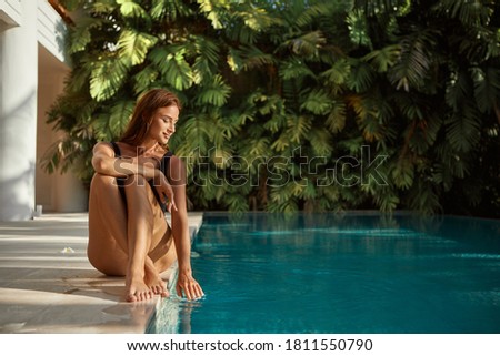 Image, Stock Photo young woman kneeling on floor feeding snacks to her cat