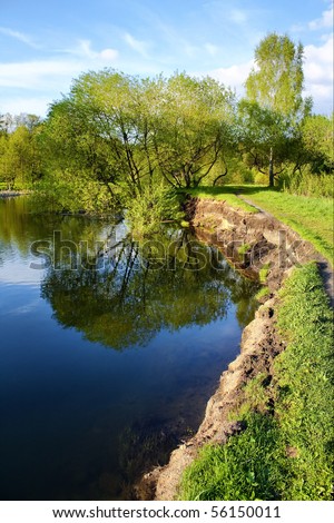 Peaceful scenic view of river with clouds and trees reflections