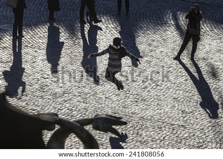 ROME, ITALY - JANUARY 2015, 05: Silhouette  people enjoy the warm temperatures in Piazza del Popolo. After days of unusual cold the sun shines back in Rome and temperatures are back to the average.