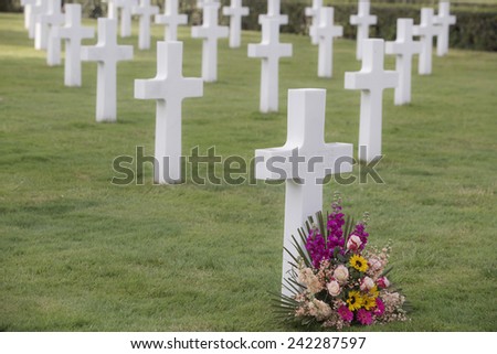 NETTUNO, ITALY - MARCH 23, 2014: American War Cemetery. A field of headstones of 7,861 of American military war dead is arranged in gentle arcs on broad green lawns to commemorate the sacrifice.
