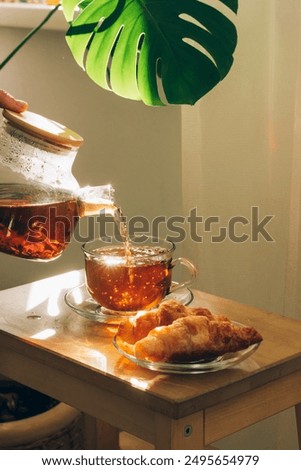 Similar – Foto Bild Ästhetisches Frühstück mit gläserner Wasserschale und rosa Blumen mit Kerze, Croissants und Teetasse