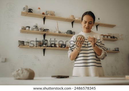 Similar – Image, Stock Photo Ceramist hands make a plate of clay